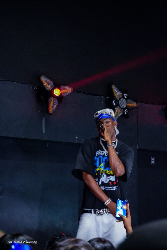 Performer engaging crowd, live concert, Winnipeg