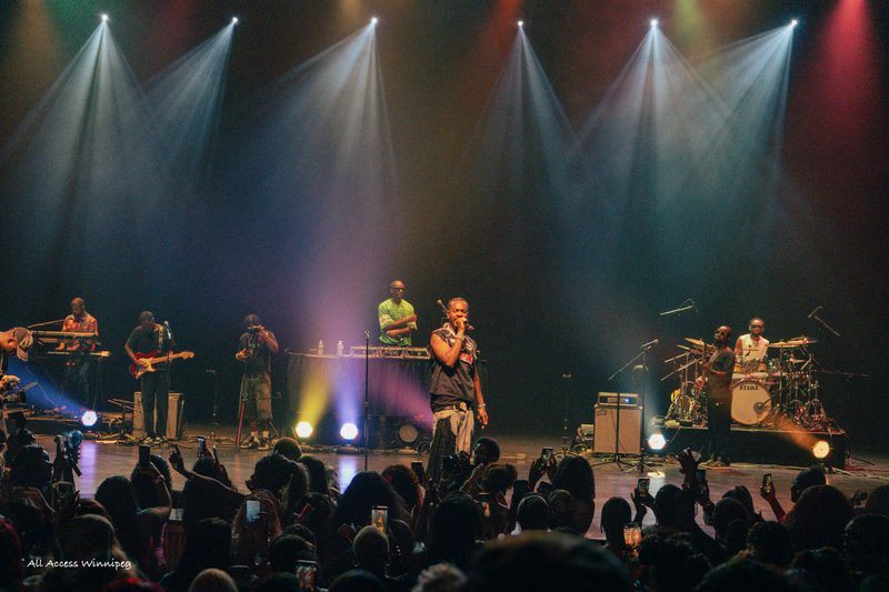 Clean shot of the artist on stage under colored spotlights, P0PS x Young Jonn, Winnipeg