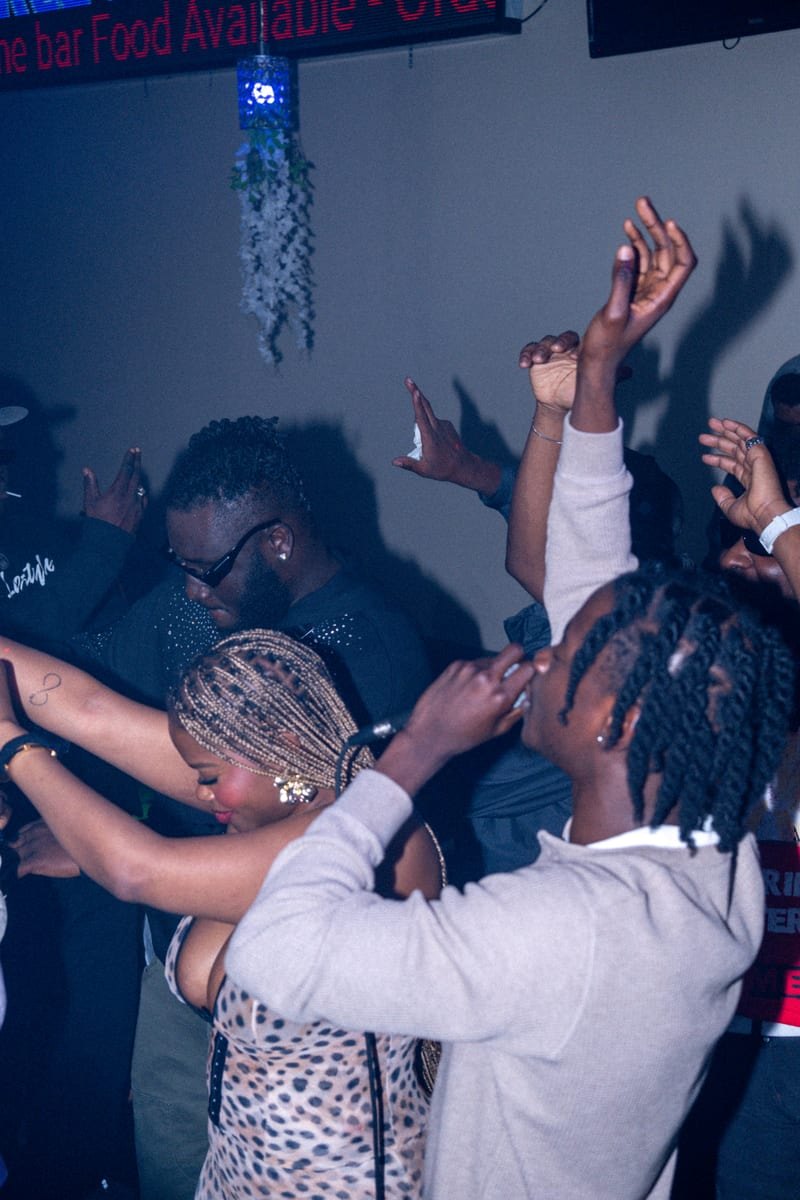 Guests dancing with their arms in the air on the dance floor