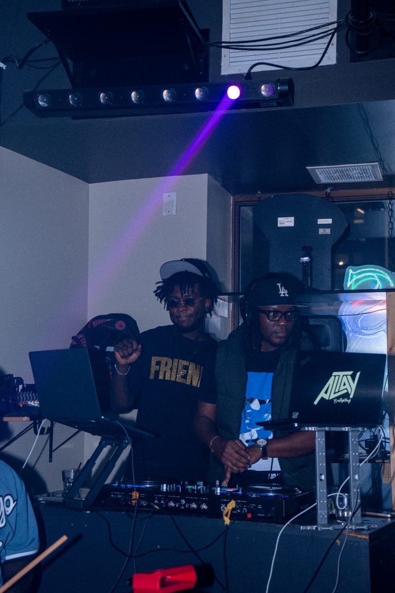 DJs at the booth under purple stage lights