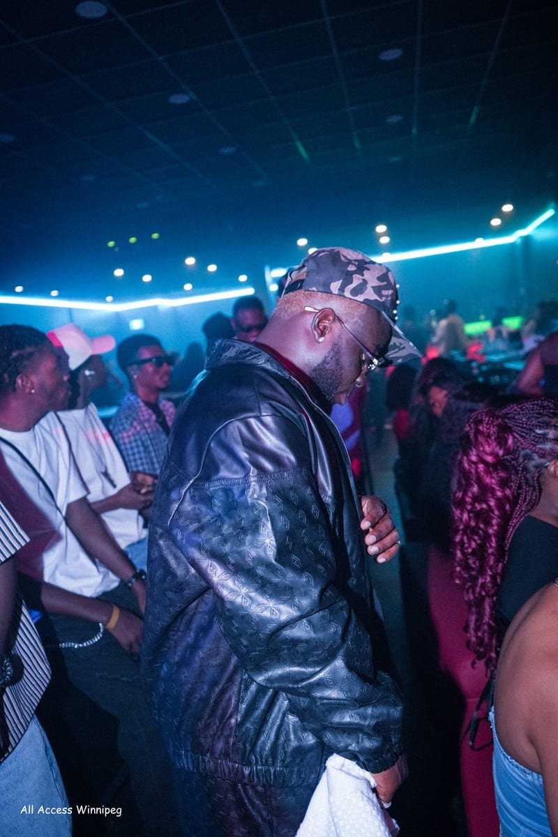 Guest dancing in the crowd under the club's laser ceiling