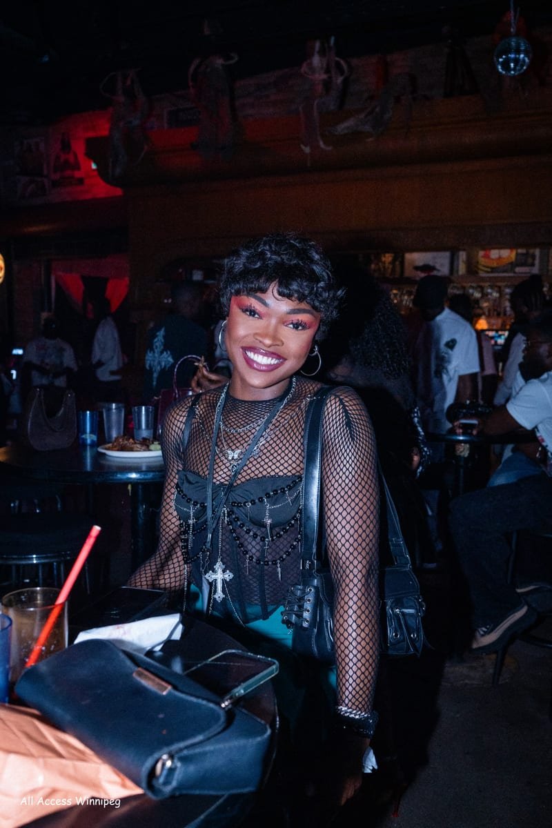 Guest smiling at her table inside the venue