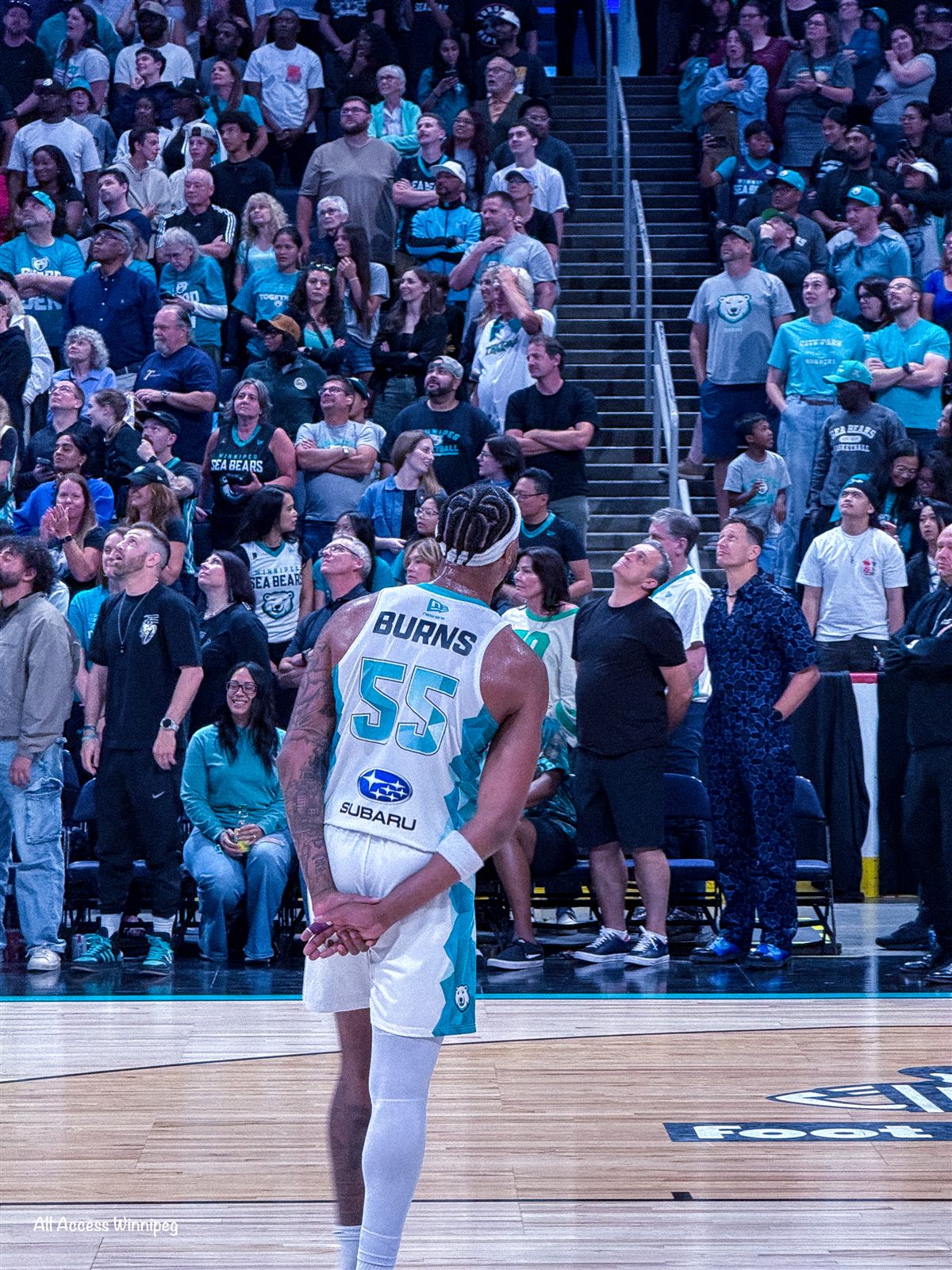 Sea Bears player Burns #55 courtside with the crowd behind him, Canada Life Centre
