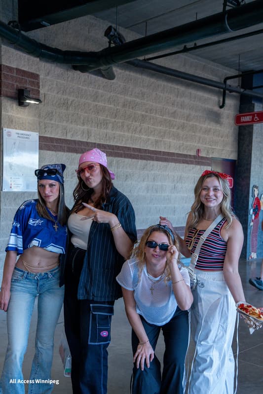 Group of four guests posed together backstage, bandanas and sunglasses