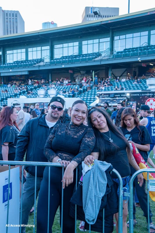 Three guests posed together near the entrance barrier