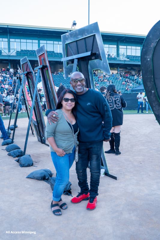 Couple posed together at a heart-shaped art installation